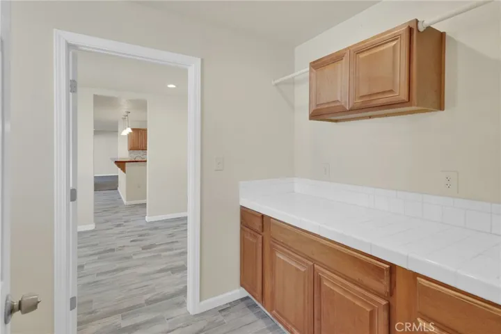 Dedicated laundry area with ample space for full-size appliances and additional storage, designed for everyday convenience