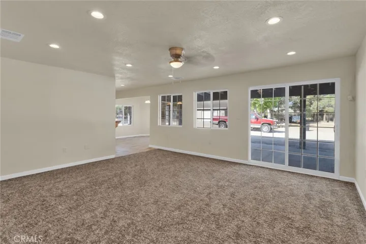 Spacious living area filled with natural light, designed with an open layout that flows seamlessly into the dining and kitchen spaces