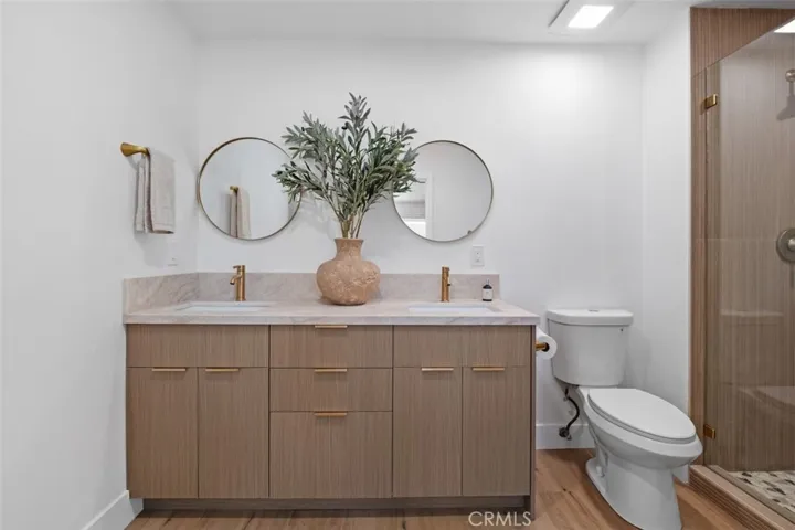 Dual sink vanity in primary suite bathroom.