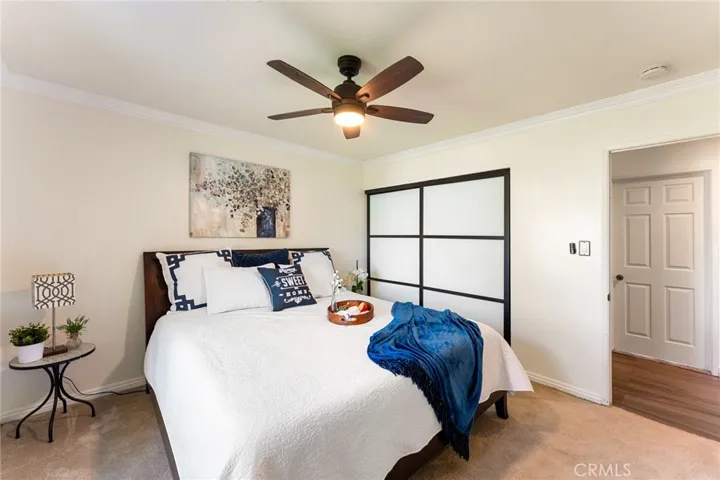 Primary Suite with Custom Closet Doors and Ceiling Fan