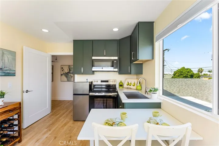 ADU Kitchen Includes Custom Cabinetry, Sink, Quartz Counters, Electric Range, Refrigerator, Microwave