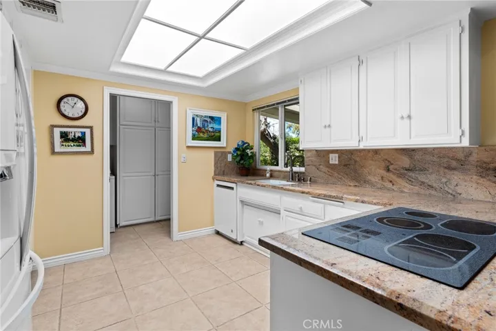 KITCHEN SHOWN WITH THE ISLAND ROLLED OUT OF THE SPACE
