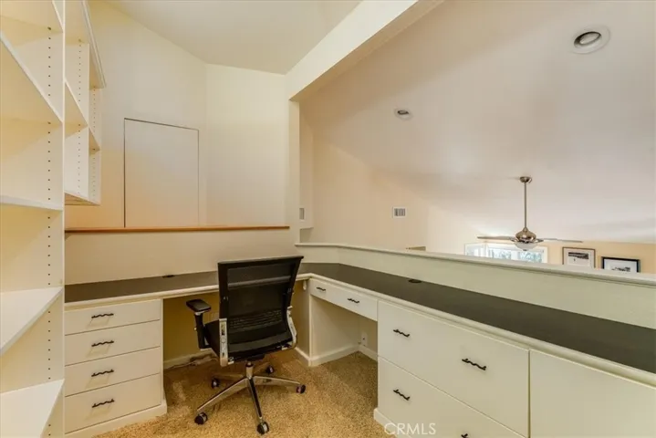 Loft office space with abundant cabinetry