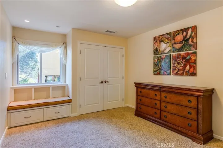 Smaller secondary bedroom with window seat.
