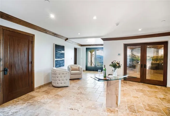 Reception area at garage level , pool, home theater and wine cellar areas