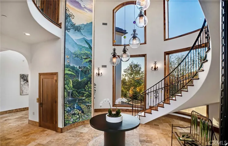 Grand 2 story foyer with incredible curved wood staircase and beautiful Mountain View