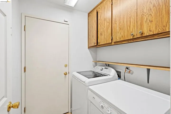 Laundry area with cabinet space and separate washer and dryer