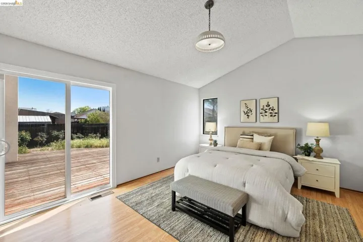 Bedroom with access to outside and light wood finished floors