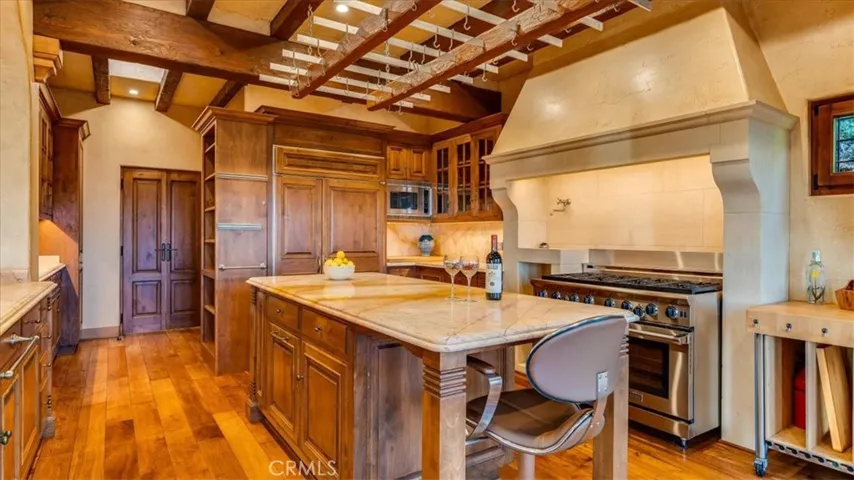 Chef's kitchen has an 8 burner stove, double ovens, pot rack, and Sub-Zero Refrigerator/Freezer.