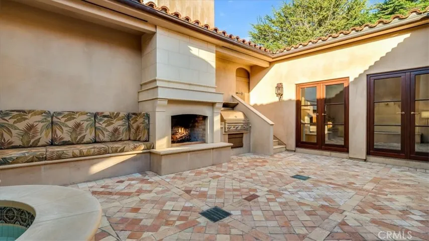 The  courtyard has a built-in grill, fireplace, built-in seating and in-ground spa with fountain.