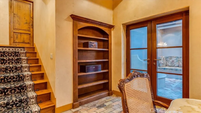 This bookcase in the dining room swings inward to reveal a hidden staircase down to the wine cellar.