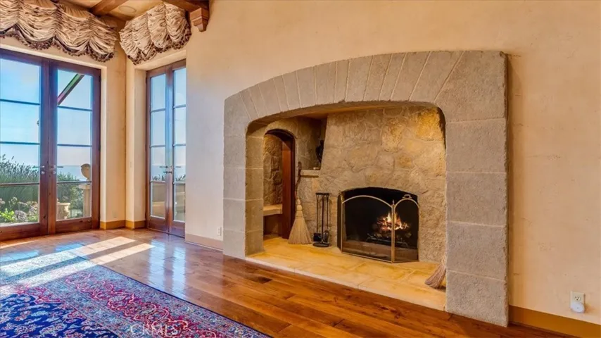 The walk-in, wood burning stone fireplace has a nook for wood storage.