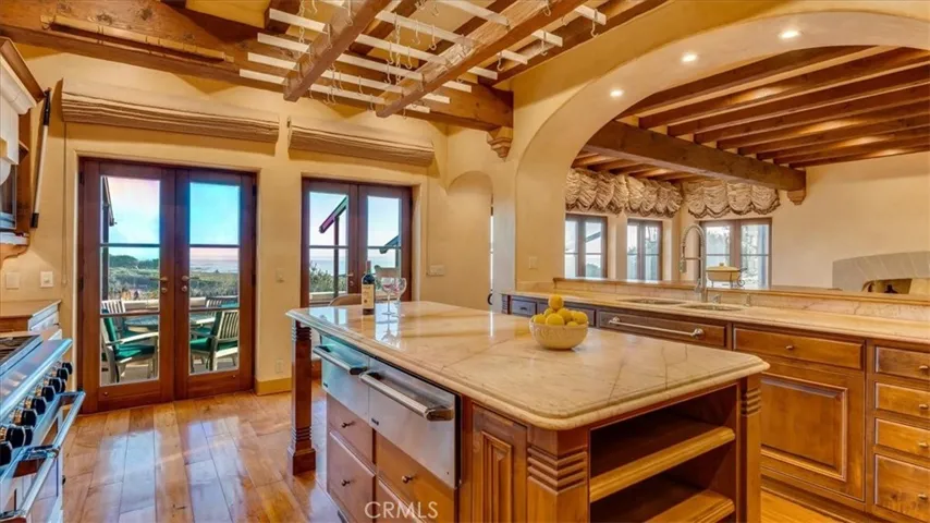 Glass doors lead to an ocean view patio.