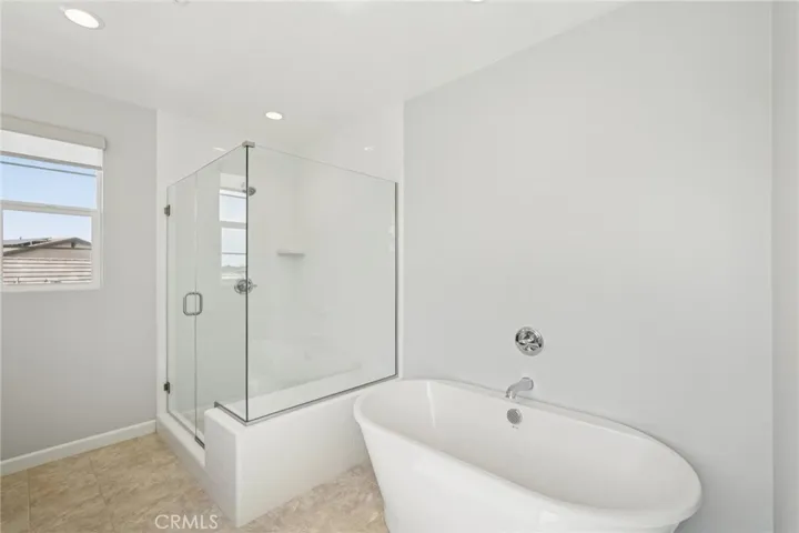 Spa-like bath with tub and glass shower