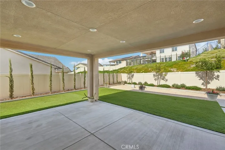 Covered patio with balcony above