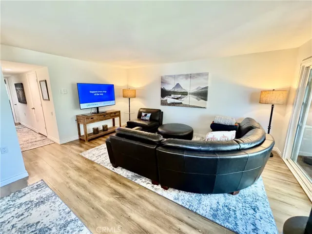 View of the Living Room Area, Also showing Hallway to Half-Bath and Primary Bedroom.