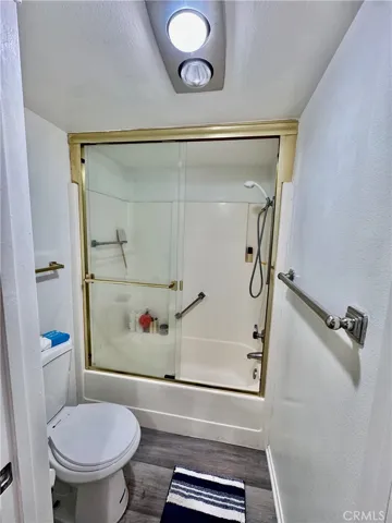 Primary Bath Area with Tub/Shower Combo and Commode .