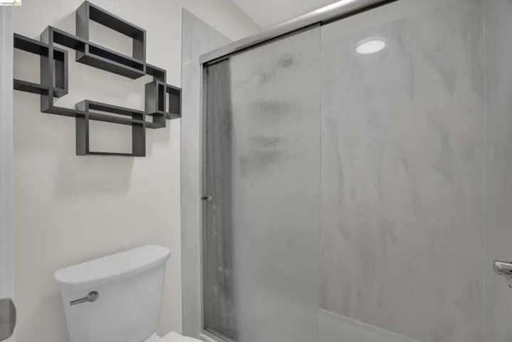 Full bathroom with a shower stall