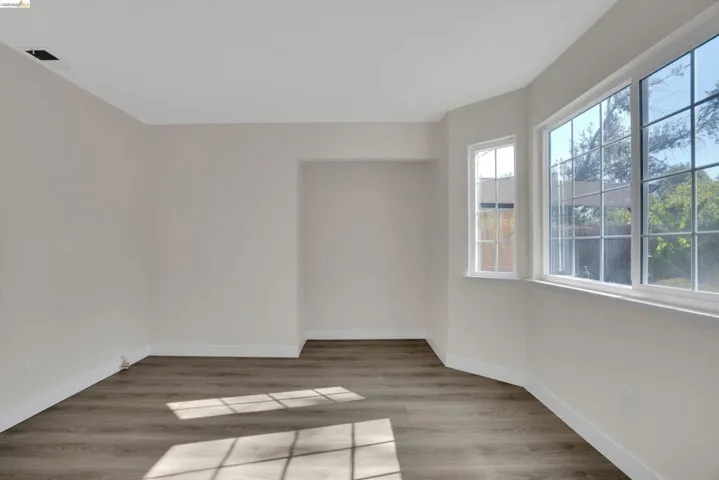 Spare room with light wood-type flooring and baseboards