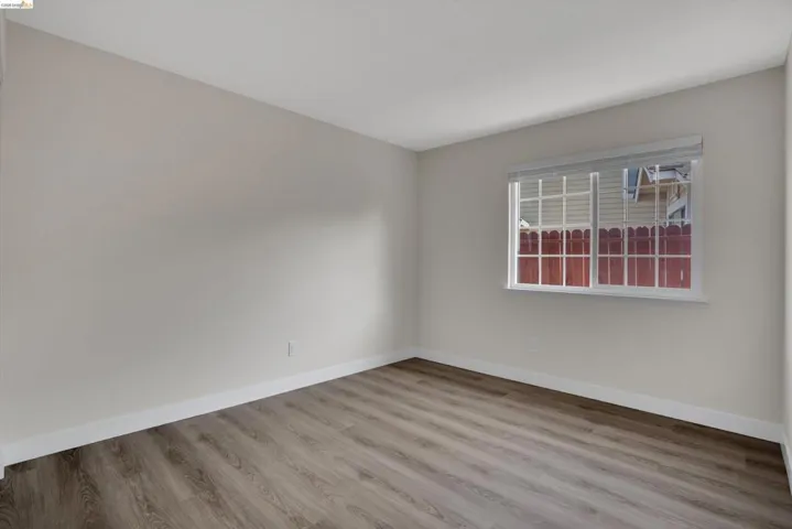 Unfurnished room featuring light wood-style floors and baseboards