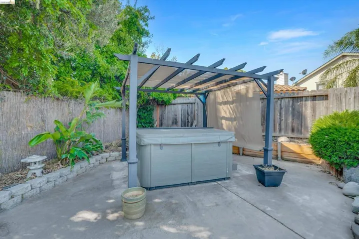 Fenced backyard featuring a pergola and a patio
