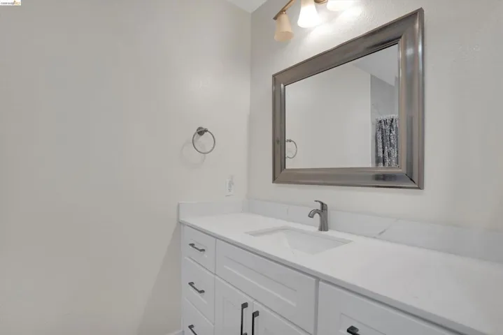 Full bathroom with vanity and a shower with shower curtain
