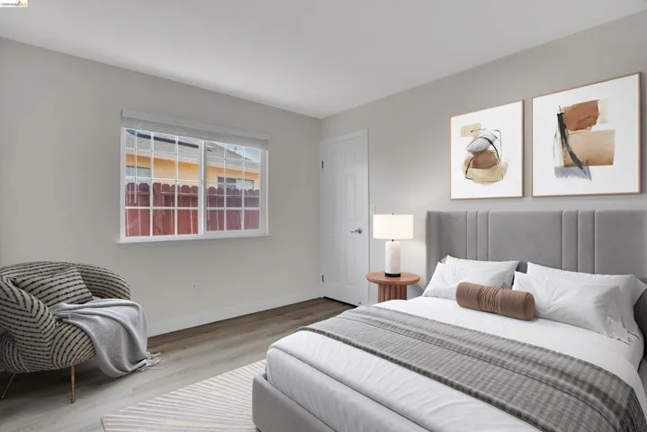 Bedroom with wood finished floors and baseboards