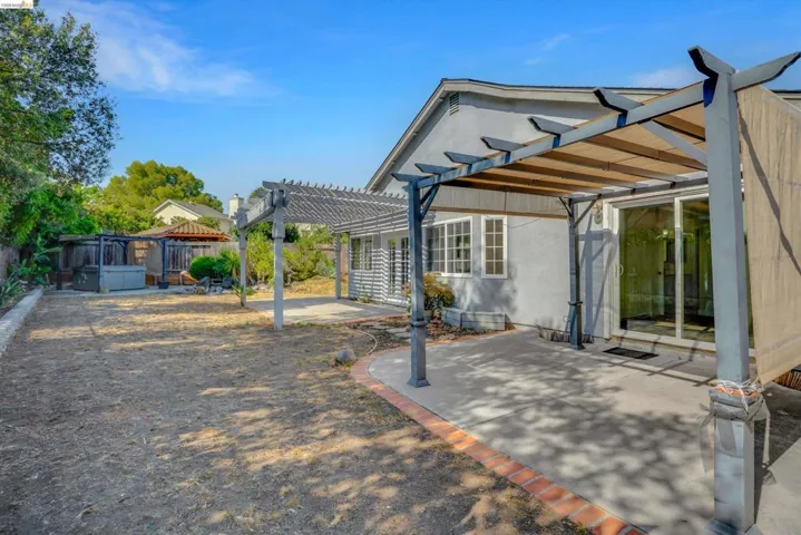 Fenced backyard featuring a patio area and a pergola