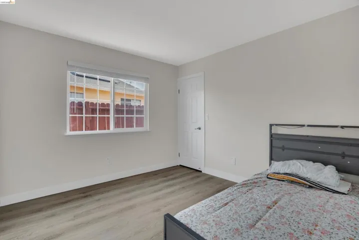 Bedroom featuring light wood finished floors and baseboards