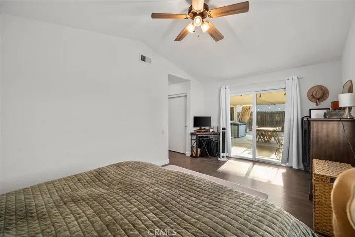 Primary bedroom with slider leading to backyard
