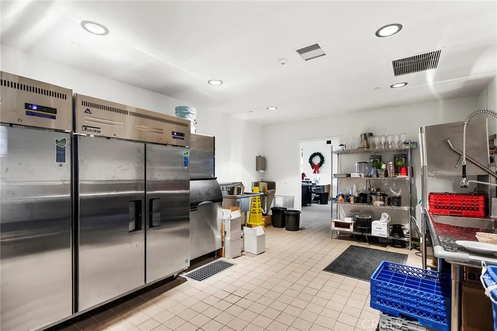 Staging area behind Tasting Room with refrigerators, Ice Machine, Sinks and Dishwasher