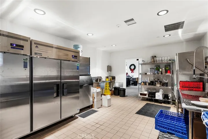 Staging area behind Tasting Room with refrigerators, Ice Machine, Sinks and Dishwasher