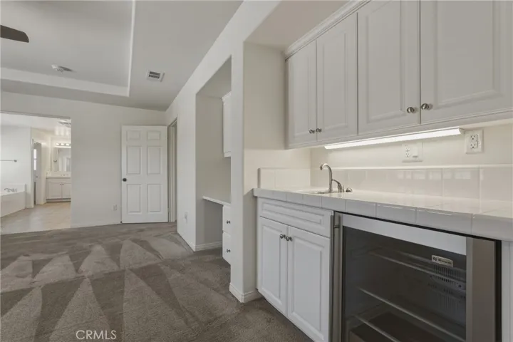 PRIMARY RETREAT WITH BUILT IN DESK, SINK AND REFRIGERATOR