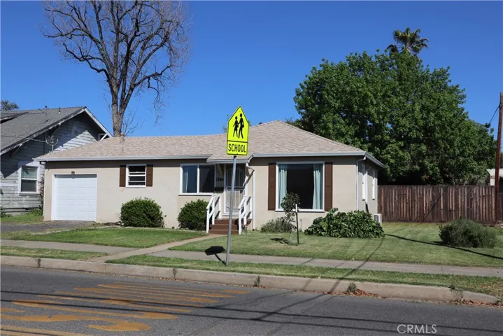 Front of the home and side yard, additional parking