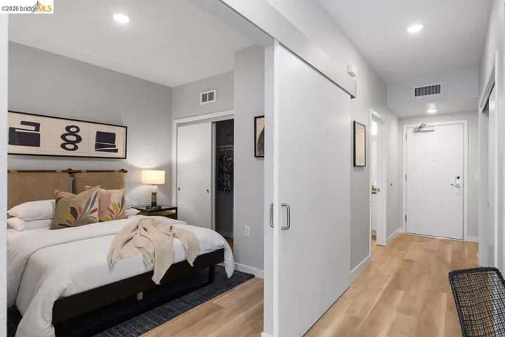 Bedroom with light wood-style flooring, a closet, and recessed lighting