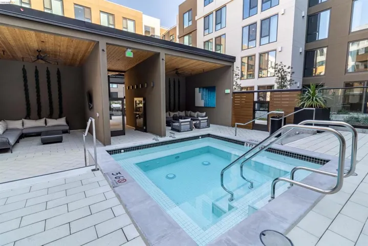 View of pool with outdoor lounge area, ceiling fan, a swimming pool, a patio area, and a hot tub