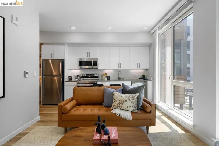Living room with light wood finished floors and recessed lighting