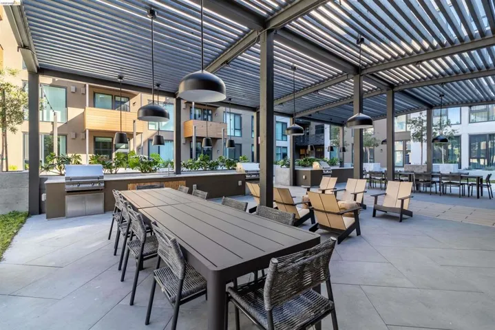 View of patio with exterior kitchen and outdoor dining space