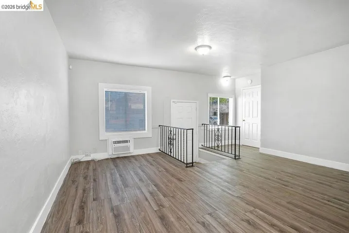 Unfurnished room featuring wood finished floors and baseboards