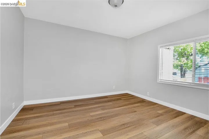 Unfurnished room featuring light wood-style floors and baseboards