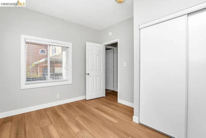 Unfurnished bedroom featuring light wood finished floors and a closet