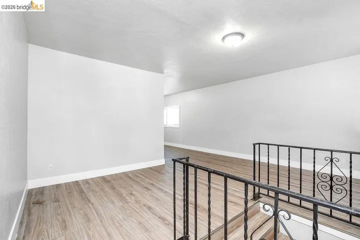 Unfurnished room featuring light wood finished floors and a textured ceiling
