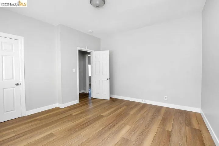 Unfurnished bedroom featuring baseboards and light wood-style floors