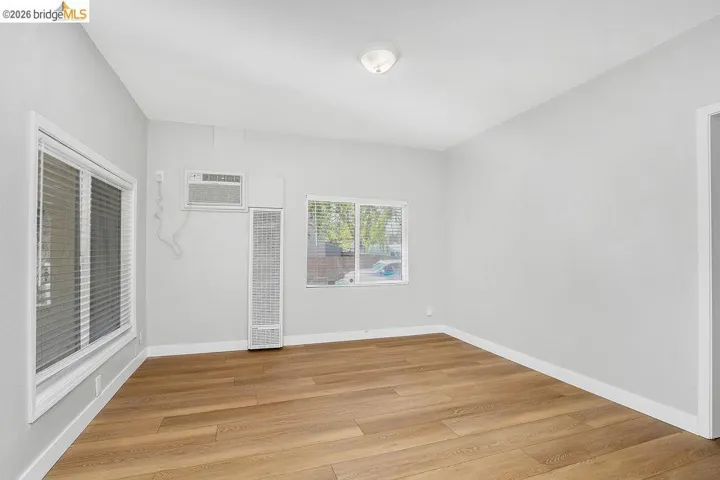Spare room featuring light wood finished floors and a heating unit