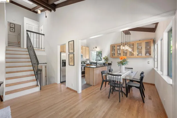 Dining area featuring light wood-type flooring, hanging lights, and lofted ceiling