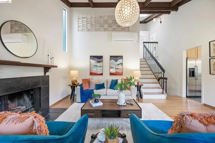 Living room with wood finished floors and a tiled fireplace