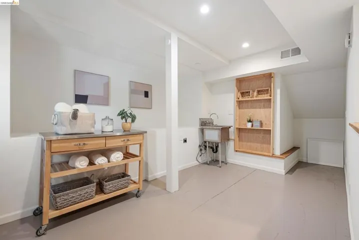 Hall featuring concrete flooring and recessed lighting
