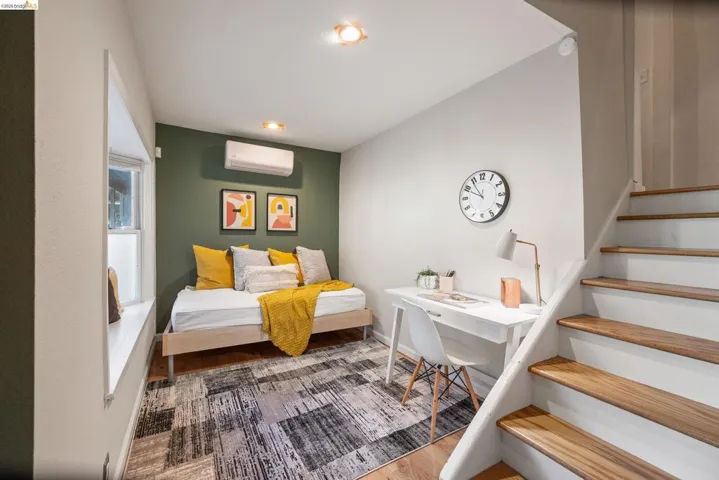 Bedroom with light wood-style floors and a mini split for heating / cooling