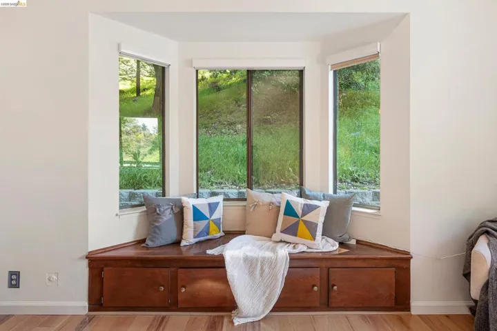 Sitting room with baseboards and wood finished floors