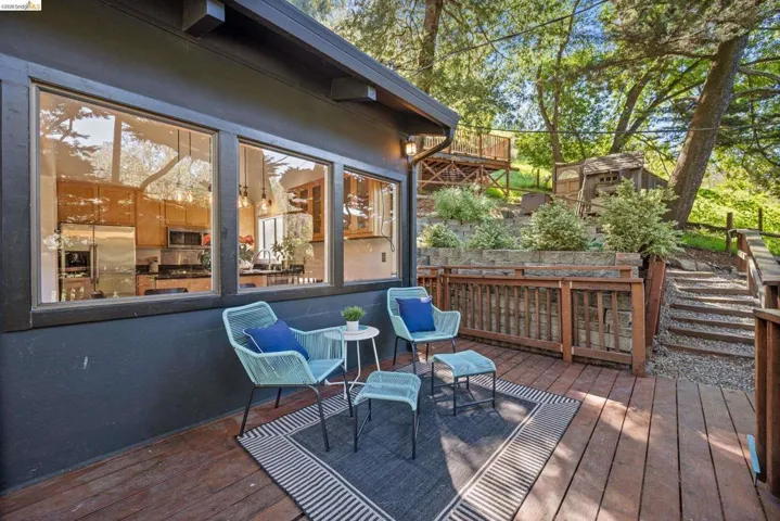 Wooden terrace featuring a storage unit